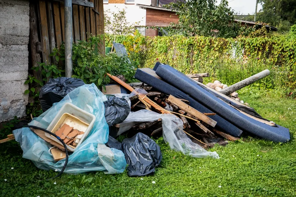 Outdoor pile of bags, garden materials, and loose yard clutter