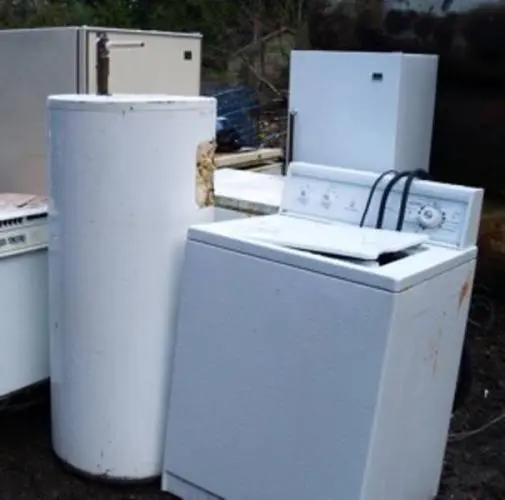 An old appliance sitting outside ready to be removed